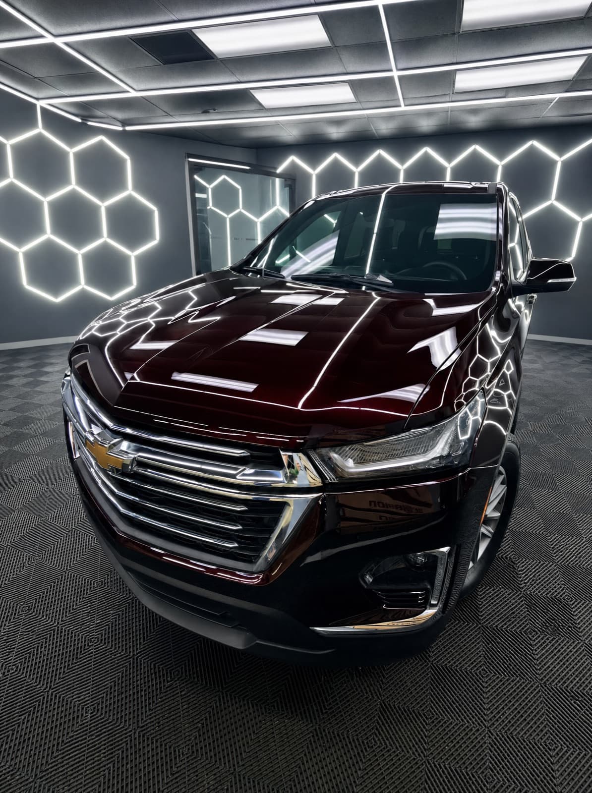 Maroon Chevrolet Traverse photographed head-on in the studio